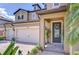 Close-up of the front entrance featuring a beautifully designed door and a three-car garage at 11205 Lark Landing Ct, Riverview, FL 33569