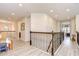 Second story hallway with wood floors and wrought iron railings and view to another area at 11205 Lark Landing Ct, Riverview, FL 33569