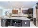 This kitchen features granite countertops and a large island with barstool seating underneath pendant lighting at 11205 Lark Landing Ct, Riverview, FL 33569