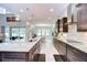 Open concept kitchen showcases dark wood cabinets, granite countertops, and a view of the dining area and backyard at 11205 Lark Landing Ct, Riverview, FL 33569