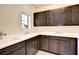 Well-organized laundry room with plenty of cabinet space and a bright window for a clean and efficient area at 11205 Lark Landing Ct, Riverview, FL 33569