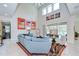 This living room offers a comfortable seating area with views of the pool and a glimpse of unique artwork at 11205 Lark Landing Ct, Riverview, FL 33569