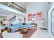 Open concept living room featuring a statement staircase, high ceilings and modern decor and furnishings at 11205 Lark Landing Ct, Riverview, FL 33569