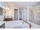 Bright primary bath with a soaking tub, shower, and double vanities with granite countertops at 11205 Lark Landing Ct, Riverview, FL 33569