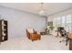 Home office featuring a patterned wall, decorative chandelier, and plantation shutters at 11205 Lark Landing Ct, Riverview, FL 33569