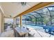 Covered outdoor dining area overlooking the screened-in pool, perfect for entertaining at 11205 Lark Landing Ct, Riverview, FL 33569