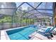 Relaxing pool area with a screened enclosure, jacuzzi, lounge chairs, and tropical landscaping at 11205 Lark Landing Ct, Riverview, FL 33569