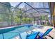 Inviting screened-in pool and patio with lounge seating and hot tub, perfect for outdoor relaxation and entertainment at 11205 Lark Landing Ct, Riverview, FL 33569