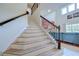 Staircase with hardwood steps and ornate railing leads up to the second floor and an open living area at 11205 Lark Landing Ct, Riverview, FL 33569