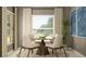 Cozy dining room with a round table, four comfortable chairs, and large windows offering plenty of natural light at 11837 Blue Diamond Trl, Parrish, FL 34219