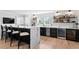 Stylish home bar featuring sleek black cabinets, a marble countertop, and beverage refrigerators at 1207 S Druid Ln, Tampa, FL 33629