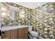 Stylish powder room features bright wallpaper, modern fixtures, and a sleek vanity at 1207 S Druid Ln, Tampa, FL 33629