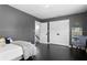 Relaxing bedroom featuring dark hardwood floors, white trim, and a bookcase with fun books at 1207 S Druid Ln, Tampa, FL 33629