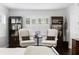 Bright bedroom featuring two chairs, a table and dark shelving units around a window with white shutters at 1207 S Druid Ln, Tampa, FL 33629