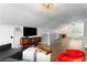 Spacious bonus room with a TV, seating area, and desk space; perfect for entertaining at 1207 S Druid Ln, Tampa, FL 33629