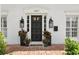 Elegant front door with brick patio, enhanced by flanking planters and stylish lighting at 1207 S Druid Ln, Tampa, FL 33629