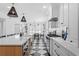 Bright open concept kitchen featuring a large island, quartz countertops, and checkered floors at 1207 S Druid Ln, Tampa, FL 33629