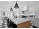 Bright kitchen featuring a large island, quartz countertops, and checkered floors at 1207 S Druid Ln, Tampa, FL 33629