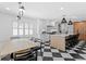 Bright open concept kitchen featuring a large island, quartz countertops, and dining area at 1207 S Druid Ln, Tampa, FL 33629