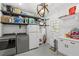 Large laundry room with modern washer and dryer, refrigerator, shelving and storage space at 1207 S Druid Ln, Tampa, FL 33629