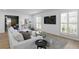 Bright living room with a large sectional sofa, modern shutters, and an open layout provides comfortable living at 1207 S Druid Ln, Tampa, FL 33629