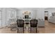 Bright living room with light wood floors, grey couches, fireplace and exposed brick wall at 1207 S Druid Ln, Tampa, FL 33629