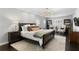 Spacious main bedroom with a decorative rug, bedside tables, and great natural light from large windows at 1207 S Druid Ln, Tampa, FL 33629