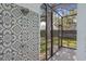 A gorgeous outdoor shower with decorative tile and stone, steps away from the pool and backyard at 1207 S Druid Ln, Tampa, FL 33629