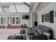 Spacious patio with modern seating, fire pit, and outdoor television for relaxed outdoor living at 1207 S Druid Ln, Tampa, FL 33629