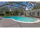 Inviting pool area with screen enclosure, lounging area, and basketball hoop for outdoor recreation at 1207 S Druid Ln, Tampa, FL 33629