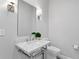 Elegant powder room features marble vanity, classic fixtures, designer mirror and sconces, with tiled flooring at 1207 S Druid Ln, Tampa, FL 33629