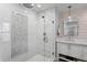 Modern walk-in shower featuring dual shower heads, subway tiles, glass enclosure, and white plank wall at 1207 S Druid Ln, Tampa, FL 33629
