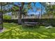 Backyard featuring a large trampoline with a basketball hoop and turf, a perfect space for outdoor activities at 1207 S Druid Ln, Tampa, FL 33629
