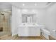 Bathroom featuring double vanity, walk-in shower, and neutral tile floors at 1209 E Cumberland Ave # 2006, Tampa, FL 33602