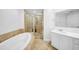 Bathroom featuring a soaking tub, walk-in shower, and single vanity at 1209 E Cumberland Ave # 2006, Tampa, FL 33602