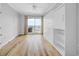 Bright bedroom with hardwood flooring, Murphy bed, ceiling fan, and large windows with city views at 1209 E Cumberland Ave # 2006, Tampa, FL 33602