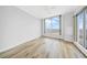 Bedroom with hardwood floors, neutral walls, and large windows offering beautiful views at 1209 E Cumberland Ave # 2006, Tampa, FL 33602
