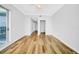 Well-lit bedroom featuring hardwood flooring, neutral walls, and a sliding door to a private balcony at 1209 E Cumberland Ave # 2006, Tampa, FL 33602