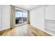 Comfortable bedroom with hardwood flooring, Murphy bed, and sliding glass door for balcony access at 1209 E Cumberland Ave # 2006, Tampa, FL 33602