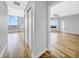 Hallway view into the living room featuring hardwood floors, neutral walls, and open floor plan at 1209 E Cumberland Ave # 2006, Tampa, FL 33602