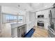 Stylish white kitchen featuring stainless appliances, a farmhouse sink, and an open view to the living area at 1209 E Cumberland Ave # 2006, Tampa, FL 33602