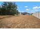 View of the back of the home and large backyard with white fence at 12256 Creek Preserve Dr, Riverview, FL 33579