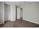 Bedroom showcasing wood floors, closet, and doorway to hall at 12256 Creek Preserve Dr, Riverview, FL 33579