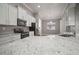 Modern kitchen with white cabinets, granite countertops, and stainless steel appliances at 12256 Creek Preserve Dr, Riverview, FL 33579