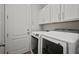 Laundry room features a washer and dryer with white cabinets at 12256 Creek Preserve Dr, Riverview, FL 33579