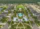 Aerial shot showcases a community with a pool, gazebo, and a central park with green lawns at 12715 Maple Bonsai Dr, Riverview, FL 33579