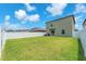 Spacious backyard with healthy lawn and a white fence, perfect for outdoor activities at 12715 Maple Bonsai Dr, Riverview, FL 33579