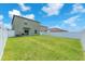 Expansive backyard with lush green grass and a white fence under a blue sky at 12715 Maple Bonsai Dr, Riverview, FL 33579