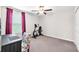 Carpeted bedroom featuring neutral walls, ceiling fan, and a window with pink curtains at 12715 Maple Bonsai Dr, Riverview, FL 33579