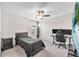 Bedroom with a black bed, gaming setup and ceiling fan at 12715 Maple Bonsai Dr, Riverview, FL 33579